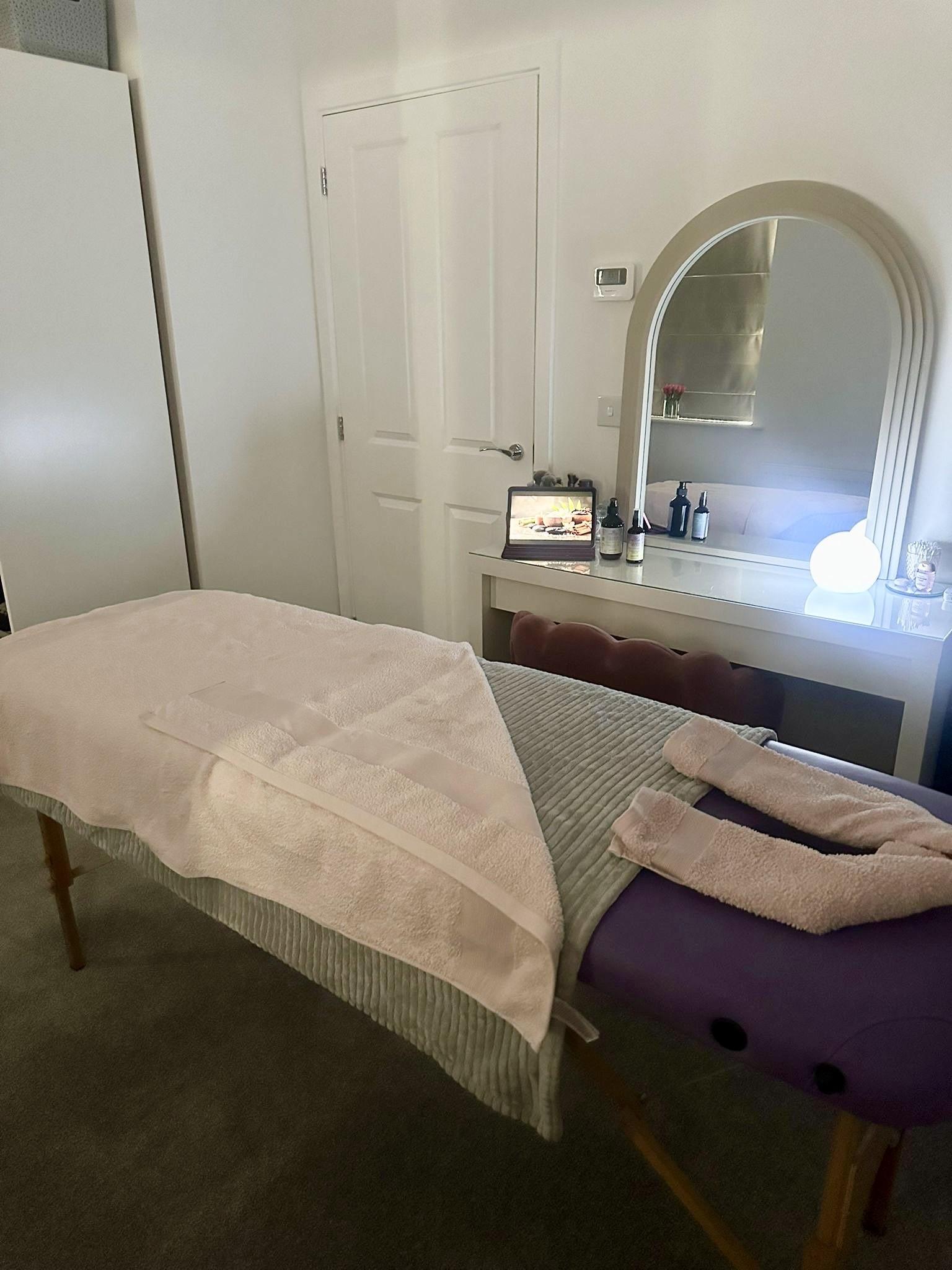 A treatment room at The Potter Sanctuary, Beck Row — soft natural light over linen and stoneware.
